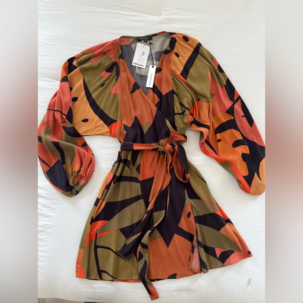 Olivaceous mini wrap around dress. Brand new with tags.  Beautiful colors.